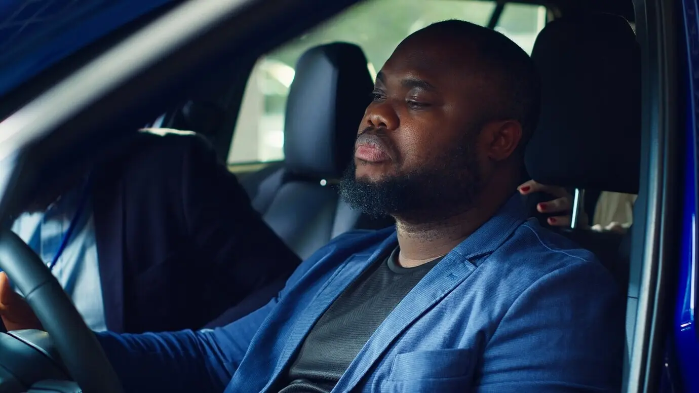 Водитель осматривает автомобиль, оценивая его характеристики и возможные неисправности.